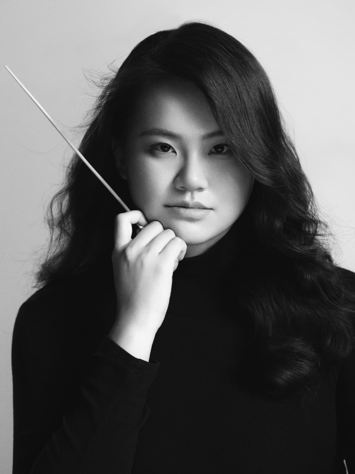 Charlotte Wang holding a conductor's baton